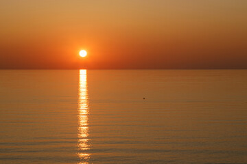 A Serene Sunset Over the Calm Waters Creates a Beautiful and Peaceful Atmosphere
