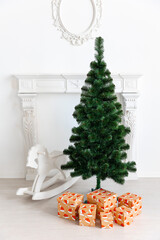 Wooden rocking horse toy in white placed on wooden floor, with decorated Christmas tree and glowing lights and fireplace in background. Concept for childhood, holiday, nostalgia, Christmas decor.