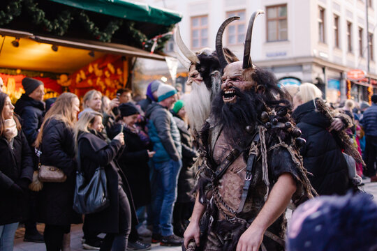 Traditional Krampuslauf parade in Germany, actors wearing scary Krampus masks and fur costumes. Alpine folklore celebration of Saint Nicholas, Bavarian winter festival, fairy-tale atmosphere