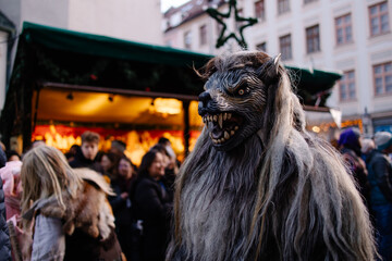 Traditional Krampuslauf parade in Germany, actors wearing scary Krampus masks and fur costumes. Alpine folklore celebration of Saint Nicholas, Bavarian winter festival, fairy-tale atmosphere