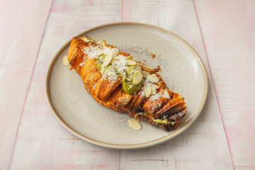 Golden croissant filled with buffalo mozzarella, roasted cherry tomatoes, and fresh basil with virgin olive oil