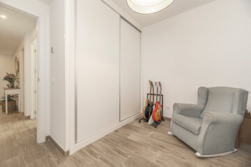 bedroom with futon bed, corner desk, and decorative wall stickers
