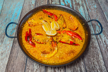 Seafood paella with sea urchins, displaying their characteristic intense orange color on the rice.