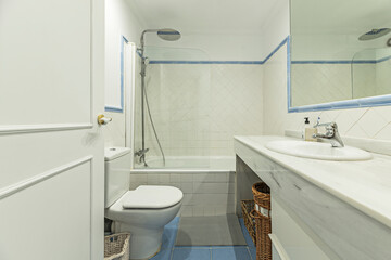 Guest bathroom with white subway tiles, a chromotherapy shower, and smart storage behind the mirror