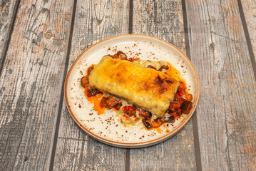 Baked cod with an almond and Provençal herb crust, served on a piquillo pepper jacket and baked potatoes