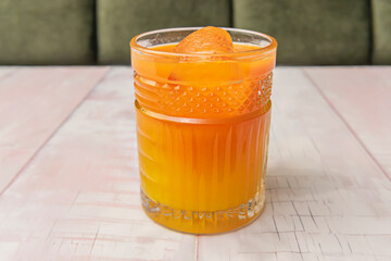 Image of a glass of orange juice with ice, perfect for hydrating with flavor
