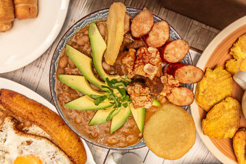 Sweet flank steak with natural tomato sauce, cooked yuca, and ripe plantain, presented on a pewter platter
