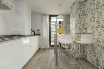  Modern kitchen with white marble center island, stainless steel appliances, and recessed LED ceiling lighting