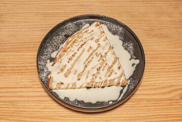 Chocolate crepes filled with milk chocolate mousse and toasted hazelnuts, topped with a scoop of...