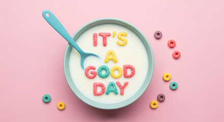 Bowl of cereal spells out it's a good day on a pink background