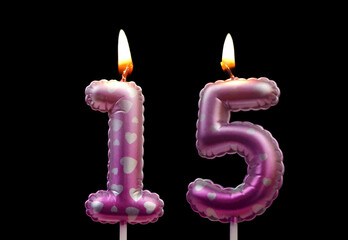 Burning air balloon shaped birthday candles with hearts isolated on black background, number 15