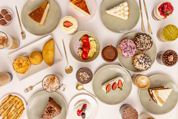 A selection of Latin American desserts: tres leches with fruit, glazed alfajores, and swirled churros with chocolate dippers.