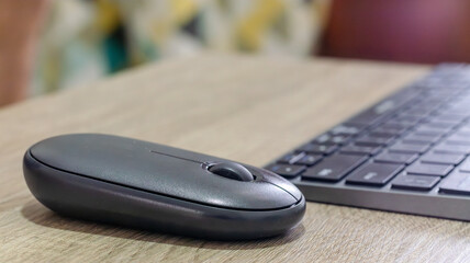 Computer keyboard and mouse on wooden table