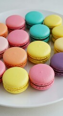 Obraz premium Collection of brightly colored meringue based confectioneries arranged on a white dish