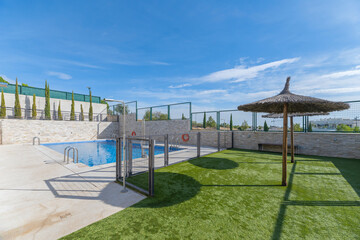 Infinity pool with a structural glass edge offering panoramic views of the valley from the mountain resort
