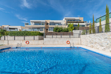 Resort-style pool area with a separate jacuzzi and service bar.