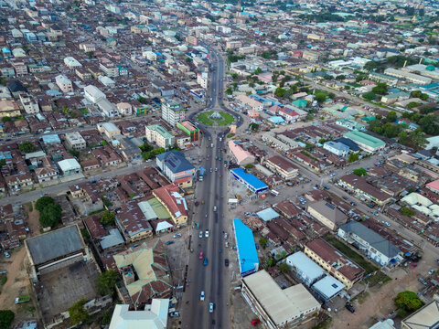 Aerial view of Ahmadu Bello Way, a major road bisecting the city, with a prominent roundabout and dense buildings, Kaduna, Kaduna, Nigeria.