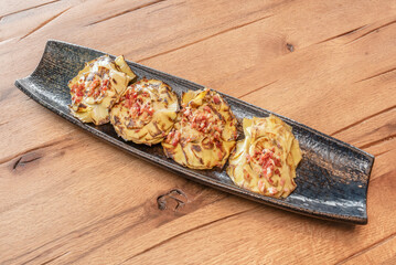 Savory artichoke blossom and ham tart with herb pastry, covered with nutmeg béchamel and gratinated with Emmental cheese