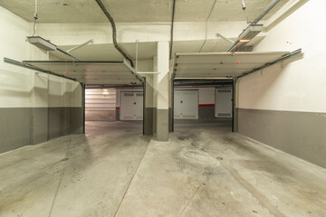Garage with a stone-clad facade to match the house, an insulated steel door, and a surveillance window.