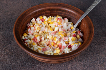Salad with crab sticks, egg, corn and sweet pepper for pita cones in brown bowl, step-by-step instructions