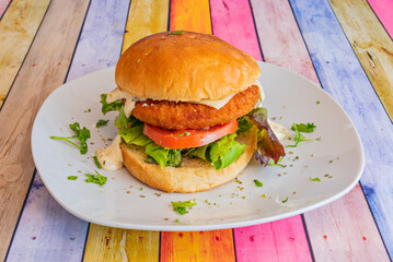 A tall and imposing burger with a brioche bun, triple beef, triple cheese, bacon, and chorizo, for the hungry