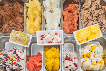 Brownie ice cream tub, with chocolate brownie chunks, walnuts, and caramel syrup, topped with vanilla ice cream