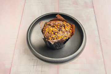 Carrot and walnut muffins with creamy cheese frosting, arranged on a collectible china plate with a...