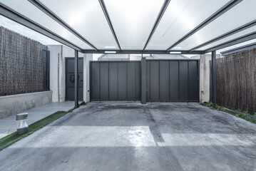 garage with access ramp, white-painted walls, and forced ventilation for added security