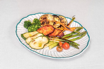 Vegetarian dish with grilled wild asparagus, portobello mushrooms, and roasted zucchini with extra virgin olive oil and fresh rosemary.