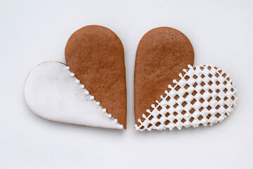 Two decorated heart-shaped gingerbread cookies on a white background