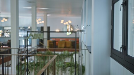 Hotel lobby scene with blurred background featuring modern interior, elegant decor, and warm lighting, creating a luxurious and inviting atmosphere.