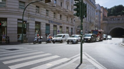 Blurry urban street scene with shallow bokeh, defocused traffic, scooters and a crosswalk in a city; backdrop copyspace backplate calm.