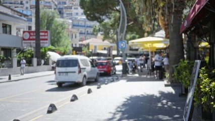 Sunlit urban street scene with soft shallow bokeh and defocused storefronts and vehicles, blurred street; background backdrop copyspace.