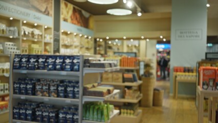 Blurred retail interior with shallow bokeh focus on shelves and aisles in a shop; background backdrop copyspace calm.