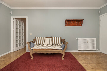 Entryway with a mirrored sliding wardrobe, jute runner rug, and wall lamps with brass arms