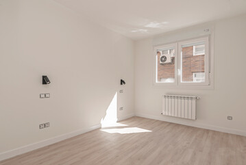 Minimalist room with oak flooring.