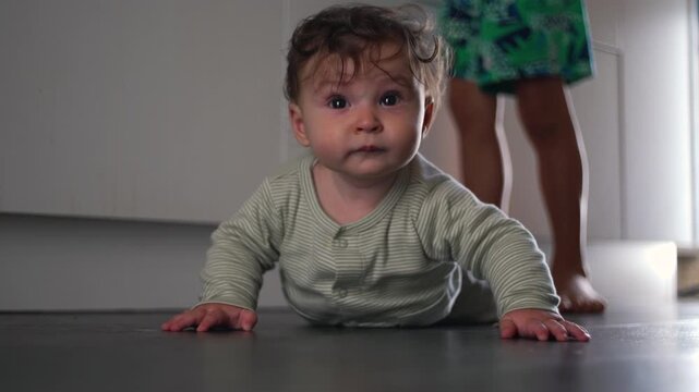 Baby crawling on kitchen floor exploring surroundings with curiosity and determination home life moment of growth and discovery - Powered by Adobe