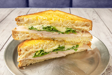 Roast Beef Sandwich: Tender slow-roasted beef, arugula, caramelized onions, and old-fashioned mustard on rustic bread