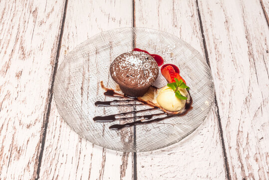 Mini chocolate souffl&eacute;s in cloud-like ceramic molds with a warm chocolate core, decorated with edible gold
