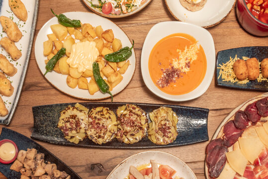 Confit artichoke blossoms with acorn-fed Iberian ham, accompanied by a red wine reduction and Parmesan shavings on an artichoke cream base