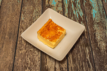  cheesecake with a crushed chocolate biscuit base, a cheese and  hunk filling, and a cream topping with a whole biscuit