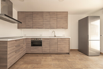 Open kitchen with dark wood island, metal stools, and brushed steel extractor hood
