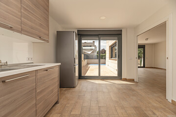Contemporary kitchen with frameless cabinetry, LED strip lighting, and porcelain stoneware flooring