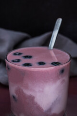 Freshly Harvested blueberries and açaí smoothie on a rustic reclaimed wood table