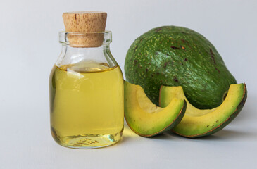 Bottle of avocado oil on white background