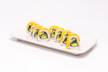 pineapple uramaki with mild curry, rolled in shredded coconut, on porcelain