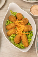 Delicious spinach and béchamel croquettes with toasted pine nuts, fried to perfection and served...