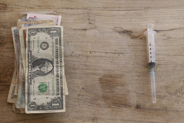 medical costs with money and syringe for a healthcare expenses concept