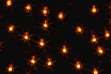 Background - electric garland with incandescent bulbs, yellow warm light, retro style, star filter
