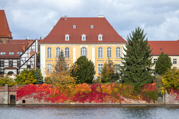 Colorful autumn view of a historic building by the Odra River in Wroclaw, Poland